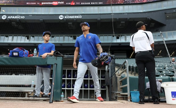 Cubs catcher Christian Bethancourt, center, exits the dugout to warm up for a game against the White Sox at Guaranteed Rate Field on Aug. 9, 2024, in Chicago. (John J. Kim/Chicago Tribune)