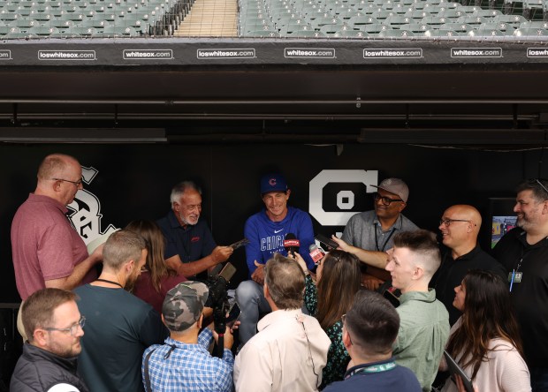 Cubs manager Craig Counsell, center, laughs while answering reporters' questions before a game against the White Sox at Guaranteed Rate Field on Aug. 9, 2024, in Chicago. (John J. Kim/Chicago Tribune)