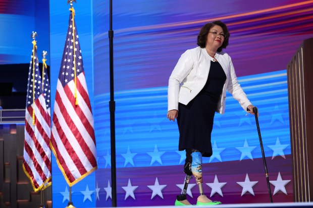 Sen. Tammy Duckworth walks onto the stage, Aug. 20, 2024, during the Democratic National Convention at the United Center. (Brian Cassella/Chicago Tribune)