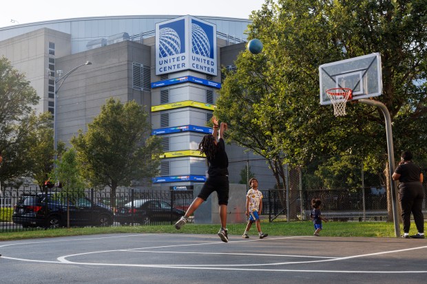 Children play on a basketball court at the Henry Horner Annex across the street from the United Center where the Democratic National Convention will be held next month Thursday July 25, 2024 in Chicago. The Henry Horner Annex sits within the vehicle screening perimeter for the DNC. (Armando L. Sanchez/Chicago Tribune)