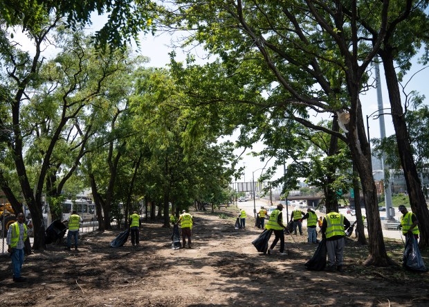 Crews clear the homeless encampment near the Dan Ryan Expressway at Roosevelt Road and South Desplaines Street, as the Democratic National Convention nears, The camp has been home to unhoused Chicagoans for at least four decades, Wednesday, July 17, 2024. (E. Jason Wambsgans/Chicago Tribune)