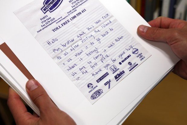 Ryan Thompson holds a photo of a conscience letter in his office on on Aug. 14, 2024. These are letters that national and state parks occasionally receive pleading for forgiveness because the person writing the letter took a rock, a plant, a shell -- something they were not supposed to remove. (Terrence Antonio James/Chicago Tribune)