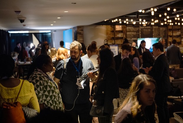 Creators mingle and produce content in a Creators Lounge at the Democratic National Convention on Aug. 21, 2024. (E. Jason Wambsgans/Chicago Tribune)