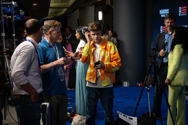 Content creators work the blue carpet area at the Democratic National Convention at the United Center on Aug. 21, 2024. (E. Jason Wambsgans/Chicago Tribune)