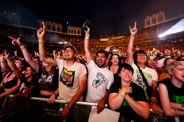 Fans watch as Green Day performs at Wrigley Field in Chicago on Aug. 13, 2024. (Tess Crowley/Chicago Tribune)