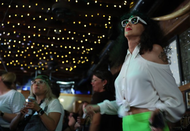 Marcella Arguello, right, dances to DJ music during the "Don't Drink the Water" dance party at The Hideout, on Aug. 8, 2024, in Chicago. (John J. Kim/Chicago Tribune)