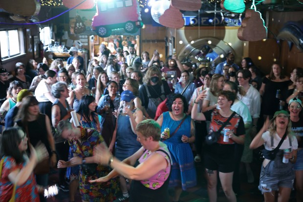 Attendees dance to deejay music during the "Don't Drink the Water" dance party at The Hideout, 1354 W. Wabansia Ave., Thursday, Aug. 8, 2024, in Chicago. The gathering was organized by essayist Samantha Irby to commemorate the 20th anniversary of the Dave Matthews Band tour bus incident, when 800 pounds of toilet waste was emptied while driving over the Kinzie Street Bridge, onto passengers of a river tour boat below. (John J. Kim/Chicago Tribune)