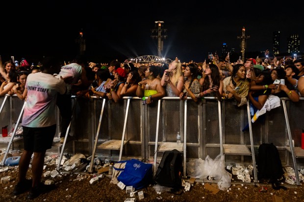 Event staff help an attendee in distress during a delay preceding Future x Metro Boomin's performance at the Bud Light stage at Lollapalooza in Chicago's Grant Park on Aug. 3, 2024. (Tess Crowley/Chicago Tribune)