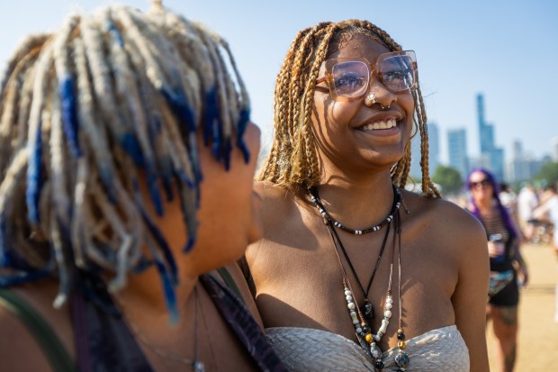 Alaina Boone, 20, of Fort Wayne, Indiana, left, and Aniya Saint-Pierre, 18, right, of Fort Wayne, Indiana, right, pose before Teddy Swims performs at T-Mobile stage at Lollapalooza in Chicago's Grant Park on Aug. 4, 2024. (Tess Crowley/Chicago Tribune)