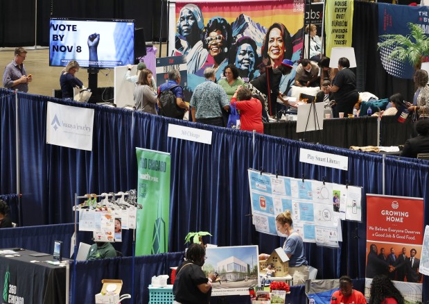 People walk through the DemPalooza exhibition at McCormick Place on Aug. 20. 2024. (Stacey Wescott/Chicago Tribune)