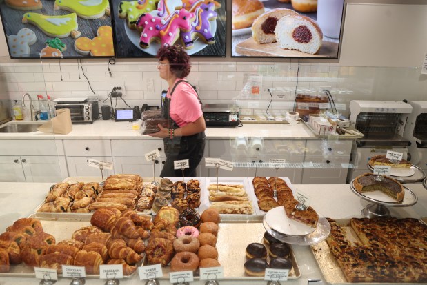 Emmi Garnier works behind the counter at Delightful Pastries on July 30, 2024, in Chicago. (Stacey Wescott/Chicago Tribune)