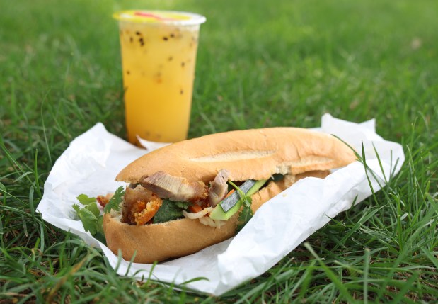 The roasted pork banh mi sandwich and the passion fruit juice drink from Nhu Lan Bakery in Chicago. (Stacey Wescott/Chicago Tribune)