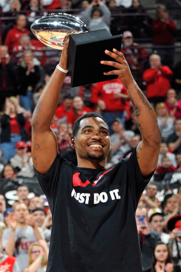 Ohio State's Braxton Miller displays the Chicago Tribune Silver Football presented to him as the Big Ten's best football player during an Ohio State-Northwestern basketball game on Feb. 14, 2013, in Columbus, Ohio. (Jamie Sabau/Getty)