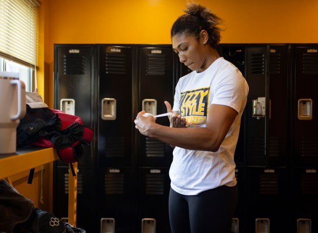 Wrestler Kennedy Blades tapes up before training for the Paris Olympics on June 19, 2024, in Addison. (Brian Cassella/Chicago Tribune)