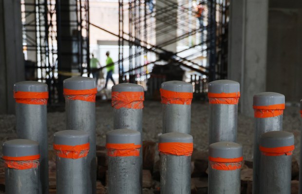 Large electrical pipes on the main level of a new 29-floor residential building being built by Clayco at 220 North Ada on Aug. 2, 2024, in Chicago. Twenty-four 24 EV charging stations are planned. (Stacey Wescott/Chicago Tribune)