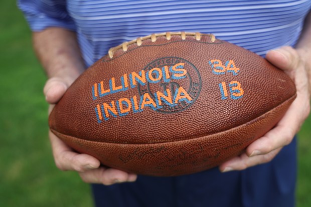 Jim Grabowski holds the football from when he broke the Big Ten rushing record during a 1965 game against Indiana. (Stacey Wescott/Chicago Tribune)