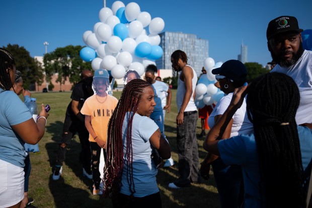 Teba Stewart, center, at a memorial vigil for her son, Ashawn Davis, 13, who was shot and killed Sunday night in Edgewater, at the former Cabrini Green site in Chicago on Aug. 13, 2024. (E. Jason Wambsgans/Chicago Tribune)