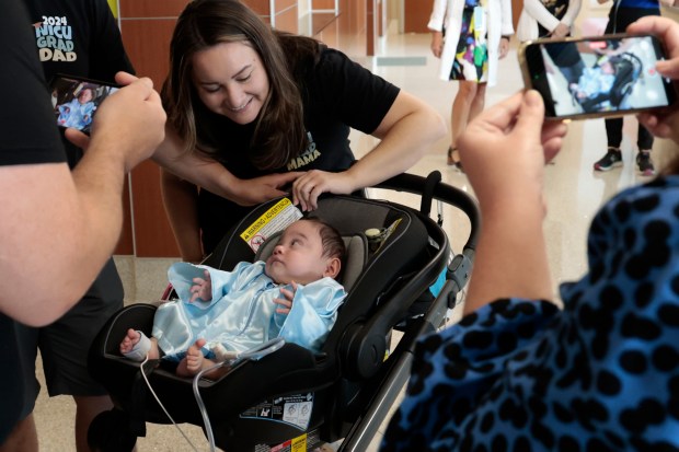 People photograph Nathan Zarate, who born at 25 weeks weighing only 14.3 ounces, before he leaves Advocate Children's Hospital after nine months in the neonatal intensive care unit, on Wednesday, Aug. 28, 2024, Park Ridge. (Antonio Perez/Chicago Tribune)