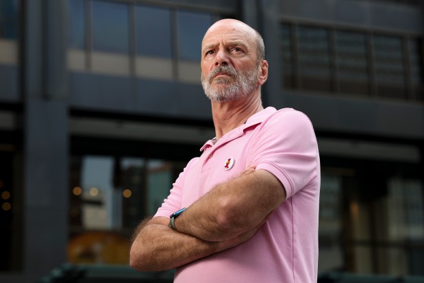 Jim P'Pool, a former Signature Room server, stands in front of 875 N. Michigan Ave., the former home of The Signature Room, in the Streeterville neighborhood on July 30, 2024. (Eileen T. Meslar/Chicago Tribune)