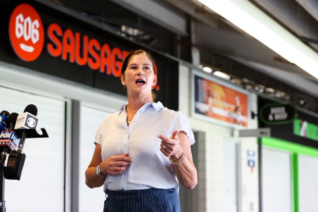 Levy Chief Creative Officer Alison Weber speaks about newly designed concession stand signs on a tour during a tasting event and hospitality exhibition at Soldier Field on Wednesday, Aug. 28, 2024. (Eileen T. Meslar/Chicago Tribune)