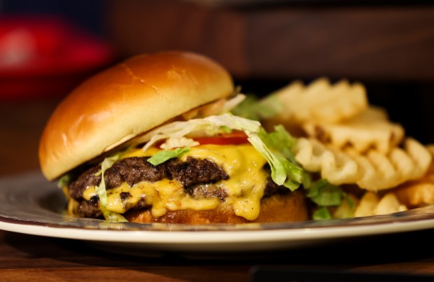 Tavern Burger, a new concession item, is displayed during a tasting event and hospitality exhibition at Soldier Field on Wednesday, Aug. 28, 2024. (Eileen T. Meslar/Chicago Tribune)