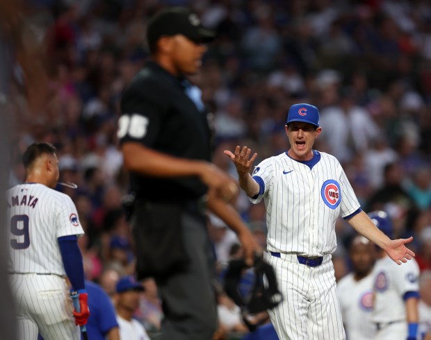 Chicago Cubs manager Craig Counsell argues with home plate umpire Jeremie Rehak after Miguel Amaya (9) struck out on an automatic strike three in the second inning of a game against the St. Louis Cardinals at Wrigley Field in Chicago on Aug. 1, 2024. (Chris Sweda/Chicago Tribune)