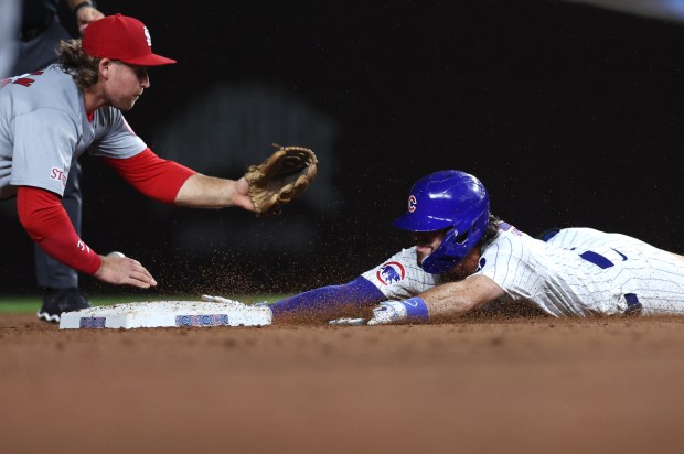 Chicago Cubs shortstop Dansby Swanson (7) slides in safely at second base with a run-scoring double in the ninth inning of a game against the St. Louis Cardinals at Wrigley Field in Chicago on Aug. 1, 2024. (Chris Sweda/Chicago Tribune)