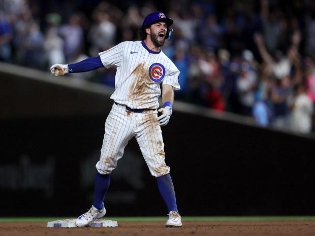 Chicago Cubs shortstop Dansby Swanson (7) celebrates at second base after driving in a run on a double in the ninth inning of a game against the St. Louis Cardinals at Wrigley Field in Chicago on Aug. 1, 2024. (Chris Sweda/Chicago Tribune)