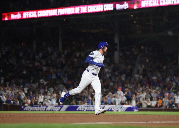 Chicago Cubs designated hitter Cody Bellinger (24) rounds the bases after hitting a solo home run in the ninth inning of a game against the St. Louis Cardinals at Wrigley Field in Chicago on Aug. 1, 2024. (Chris Sweda/Chicago Tribune)