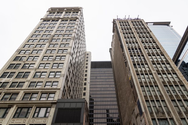 The Consumers, left, and Century Buildings, at 220 and 202 S. State St., remain in danger of demolition from the federal government's plan to protect Dirksen U.S. Courthouse, rear, on March 5, 2024, in the Loop. (Brian Cassella/Chicago Tribune)