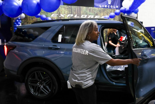 Plant manager Angela Weathers opens the doors of a 2025 Ford Explorer SUV inside Ford's Chicago Assembly Plant during an open house event celebrating the plant's 100th anniversary on Aug. 4, 2024. (Eileen T. Meslar/Chicago Tribune)