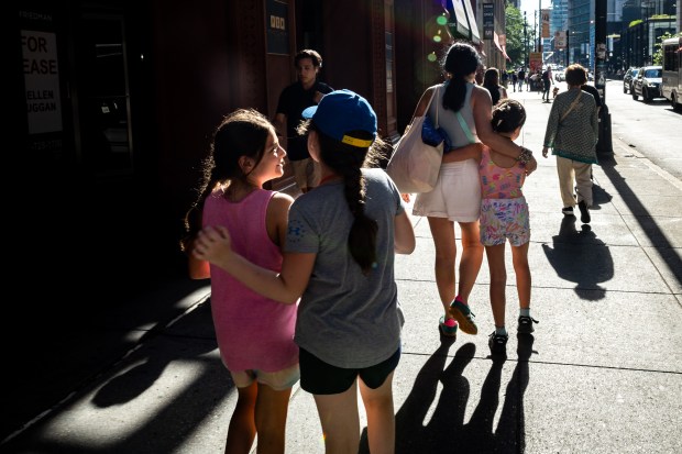 People walk along West Jackson Boulevard near South Wells Street in Chicago on July 17, 2024. (Tess Crowley/Chicago Tribune)