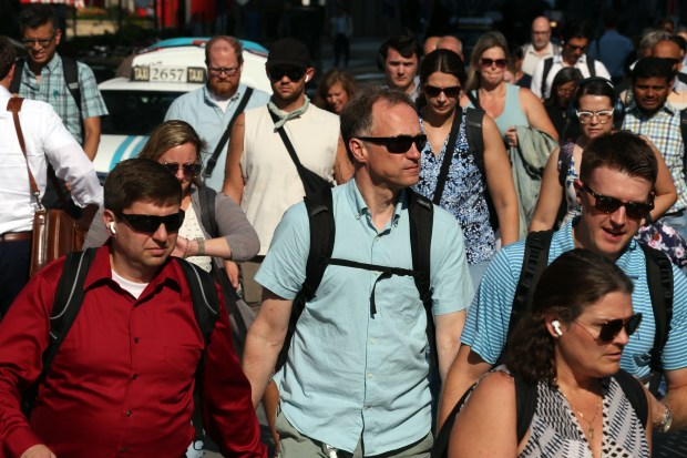 Sunglasses are popular with people walking west on Adams Street towards Union Station in Chicago in the afternoon sunlight as the temperature hovers near 100 degrees on Monday, Aug. 26, 2024. (Terrence Antonio James/Chicago Tribune)