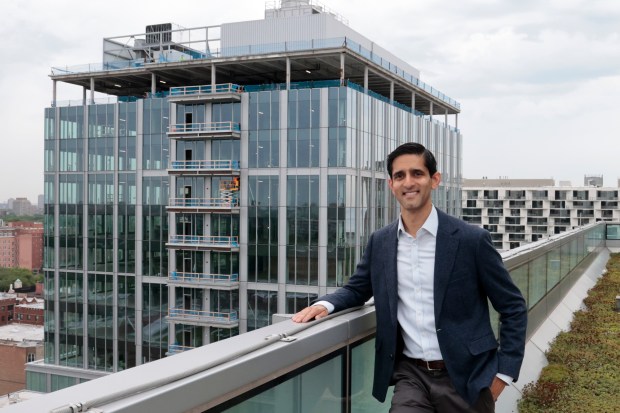 President of the Polsky Center, Samir Mayekar stands on a balcony overlooking the ongoing construction of Hyde Park Labs, a new science focused building on the University of Chicago's Hyde Park campus, Aug. 1, 2024. (Antonio Perez/Chicago Tribune)