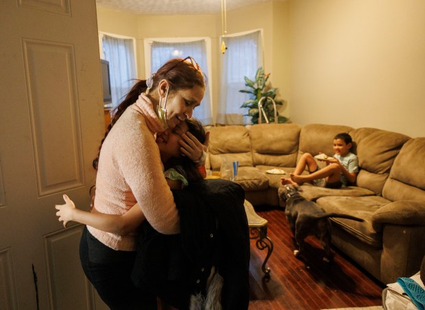 Esperanza Mendez hugs her daughter Yuledy after returning home from Stroger Hospital after having her lipoma surgically removed on Jan. 30, 2024. (Armando L. Sanchez/Chicago Tribune)