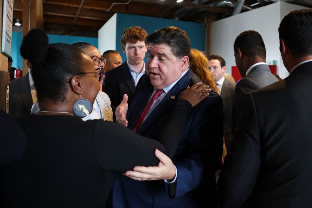 Gov. JB Pritzker speaks to people after signing the returning citizens identification access bill at the Women's Justice Institute on Aug. 6, 2024. (Eileen T. Meslar/Chicago Tribune)