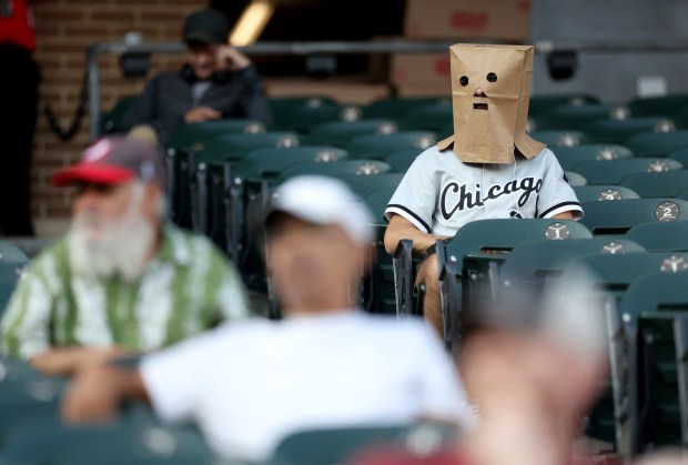 A White Sox fan wears a bag over his head while taking in a game between the Sox and the Rangers at Guaranteed Rate Field on Aug. 28, 2024. (Chris Sweda/Chicago Tribune)