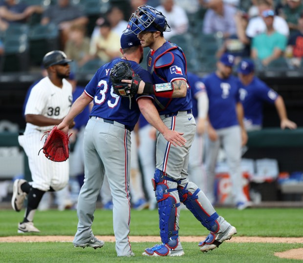 Texas Rangers pitcher Kirby Yates (39) and catcher Jonah Heim (28) celebrate after closing out the Chicago White Sox in game 1 of a doubleheader at Guaranteed Rate Field in Chicago on Aug. 28, 2024. (Chris Sweda/Chicago Tribune)