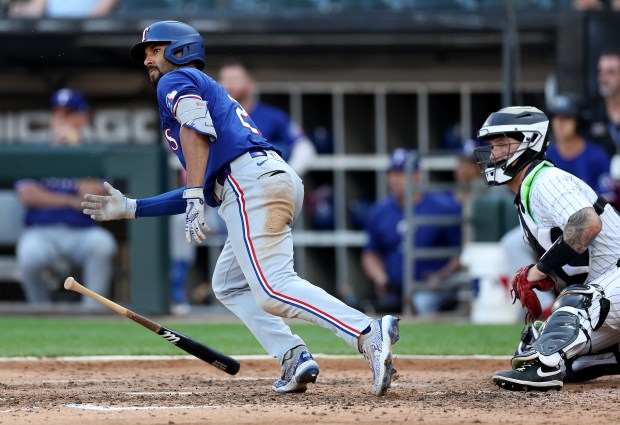 Texas Rangers second baseman Marcus Semien (2) sprints out the batters box as he drives in a run on a double in the seventh inning of a game against the Chicago White Sox at Guaranteed Rate Field in Chicago on Aug. 28, 2024. (Chris Sweda/Chicago Tribune)