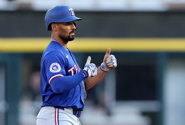 Texas Rangers second baseman Marcus Semien (2) gives a thumbs up to his teammates after driving in a run on a double in the seventh inning of a game against the Chicago White Sox at Guaranteed Rate Field in Chicago on Aug. 28, 2024. (Chris Sweda/Chicago Tribune)