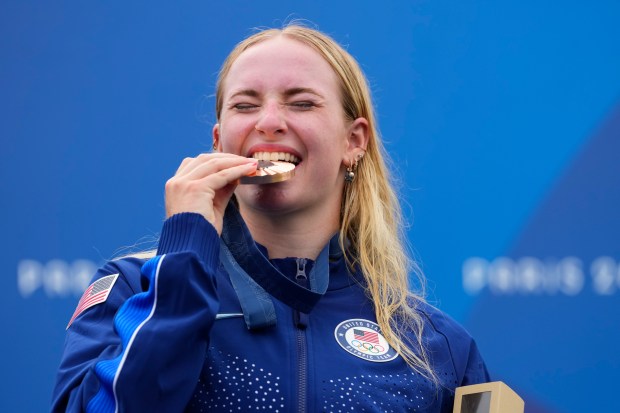 Evy Leibfarth of the United States celebrates with the bronze medal in the women's canoe single finals at the 2024 Summer Olympics, Wednesday, July 31, 2024, in Vaires-sur-Marne, France. (AP Photo/Kirsty Wigglesworth)