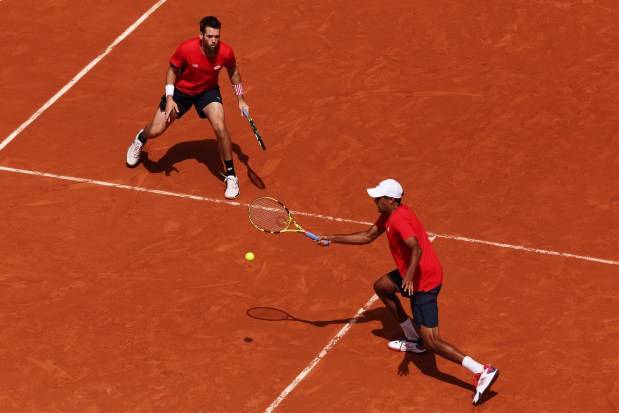 Rajeev Ram of Team United States plays a forehand as he plays with Austin Krajicek of Team United States during the Tennis Men's Doubles Gold Medal match against Matthew Ebden and John Peers of Team Australia on day eight of the Olympic Games Paris 2024 at Roland Garros on Aug. 03, 2024 in Paris, France. (Photo by Clive Brunskill/Getty Images)