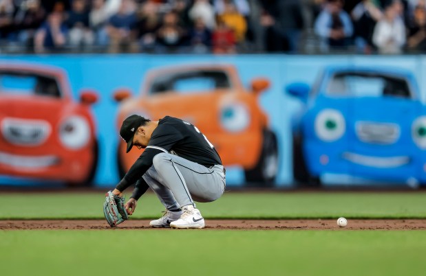 White Sox's Miguel Vargas stays down after misfielding a ball hit by the Giants' Curt Casali in the third inning on Aug. 20, 2024. (Carlos Avila Gonzalez/San Francisco Chronicle via AP)