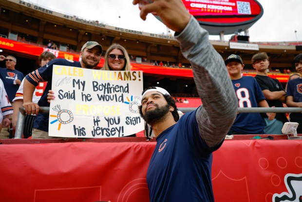 Caleb Williams #18 of the Chicago Bears poses for a selfie with Chicago Bears fans prior to a preseason game against the Kansas City Chiefs at GEHA Field at Arrowhead Stadium on Aug. 22, 2024 in Kansas City, Missouri. (Photo by David Eulitt/Getty Images)