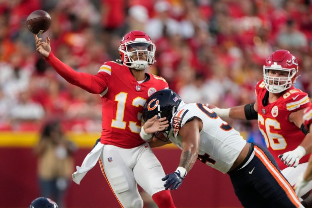 Bears defensive end Austin Booker hits Chiefs quarterback Chris Oladokun during the first quarter of a preseason game on Aug. 22, 2024, in Kansas City, Mo. (Charlie Riedel/AP)