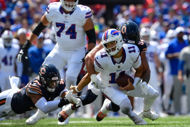 Buffalo Bills quarterback Mitchell Trubisky (11) is sacked by Chicago Bears' Austin Booker (94) during the first half of an preseason NFL football game, Saturday, Aug. 10, 2024, in Orchard Park, NY. (AP Photo/Adrian Kraus)