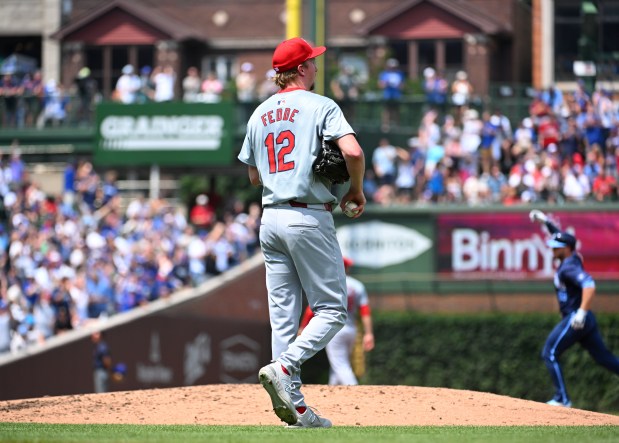 Cardinals starter Erick Fedde reacts after giving up a home run to Cubs first baseman Michael Busch (background) during the second inning on Aug. 2, 2024, at Wrigley Field. (Nuccio DiNuzzo/Getty Images)