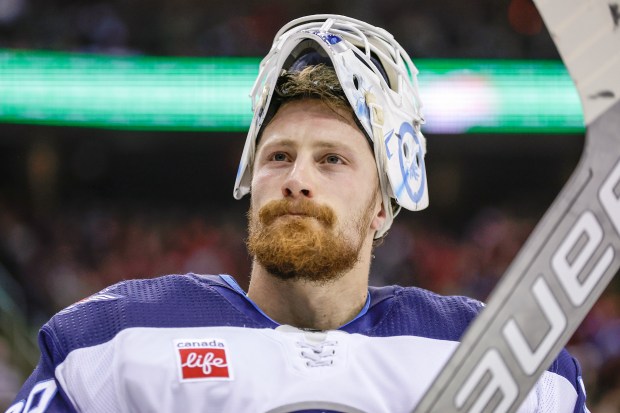 Jets goaltender Laurent Brossoit looks on during a break in the action in a game against the Devils on March 21, 2024, in Newark, N.J. (Adam Hunger/AP)