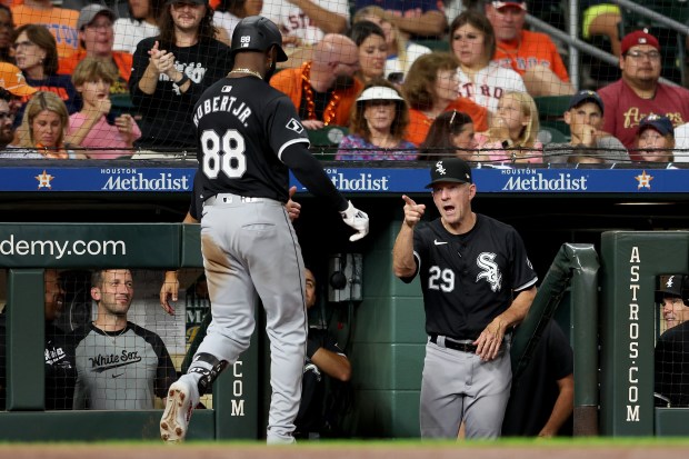 White Sox center Fielder Luis Robert Jr. is congratulated by bench coach Doug Sisson after hitting a solo home run in the fifth inning against the Astros on Aug. 16, 2024, at Minute Maid Park in Houston. (Tim Warner/Getty)