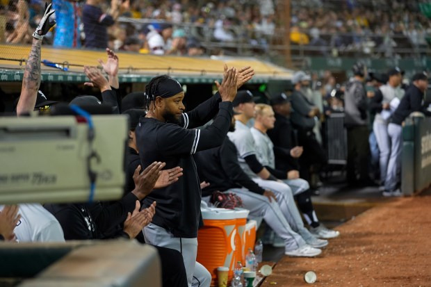 White Sox players cheer in the dugout after Lenyn Sosa's RBI single during the ninth inning against the Athletics on Aug. 6, 2024, in Oakland, Calif. (Godofredo A. Vásquez/AP)